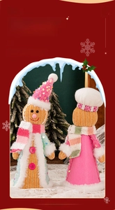 Detail showing two plush gingerbread dolls with sequins and knitted textures for Christmas