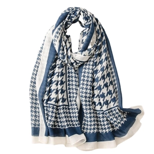 Navy blue and beige houndstooth scarf with soft woven texture in a classic drape style