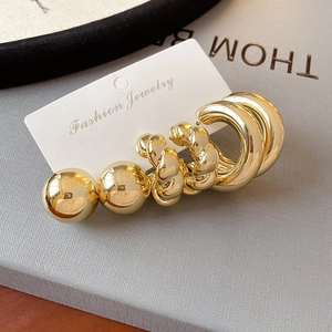 Exaggerated gold oval C-shaped hoop earrings set with smooth polished finish for women