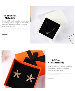 Detail view of necklace and flower earrings displayed in elegant orange and white gift boxes