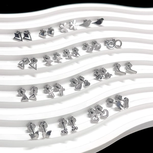 Detailed view of collection featuring silver heart, butterfly, and star titanium earrings