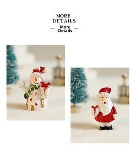 Close-up of resin Santa Claus and snowman figurines with festive gift box details
