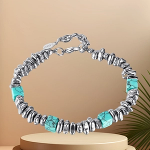Detail of stainless steel bracelet featuring turquoise stone beads and engraved S.Steel tag