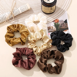 6-pack of vintage silk satin scrunchies in assorted retro colors on a cozy decor mat