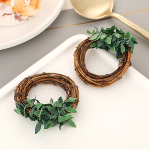 Detail of hand-woven rattan napkin ring with green leaves on a white ceramic plate