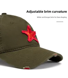 Close-up of distressed army green baseball cap brim with red star embroidery detail