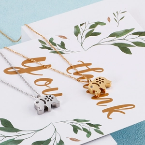 Cute elephant pendant necklace in gold and silver titanium steel with hollow flower design