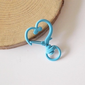 Close-up of light blue heart-shaped alloy lobster clasp with a rotating swivel base