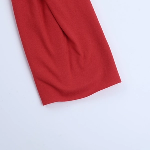 Close-up detail of the red knitted fabric texture for the halter backless jumpsuit set