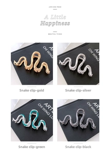 Detail view showing snake-shaped metal hair claws in gold, silver, black, and emerald green