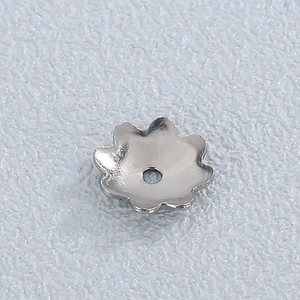 Detailed view of silver flower-shaped stainless steel bead cap for DIY jewelry making