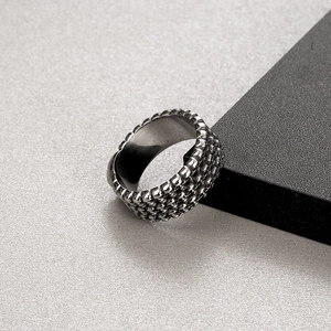 Detailed view of gothic skull ring with textured dark metal finish and industrial style