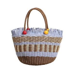 Handmade striped woven straw bucket bag with colorful beads and fringe detail