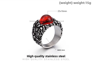 Macro view of men's punk stainless steel ring with red stone and lava rock texture