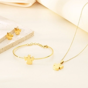 Detail of gold angel jewelry set featuring necklace, bracelet and earrings on silk
