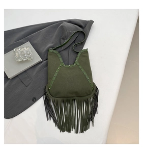 Detail of army green suede shoulder bag featuring bohemian sun face and long fringes