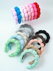 Macro detail of plush velvet spa headbands in diverse colors with soft cloud texture