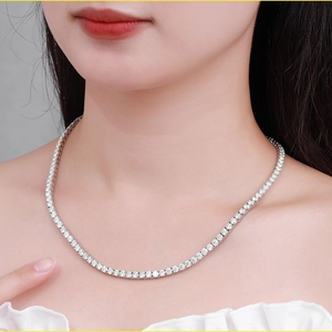 Close-up of luxury moissanite tennis necklace worn by a model showcasing silver shine