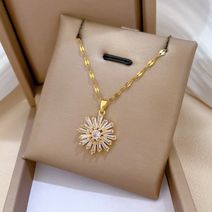 Macro shot of gold-plated titanium sunflower pendant with cubic zirconia stones