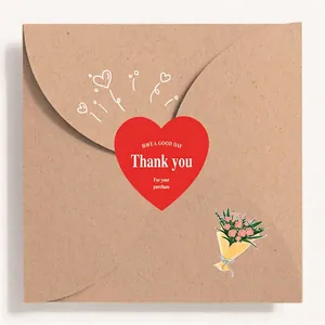 Red heart-shaped Thank You stickers on brown kraft envelope for gift sealing