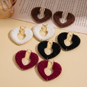 Knitted hollow heart hoop earrings in brown, white, black, and burgundy with gold beads