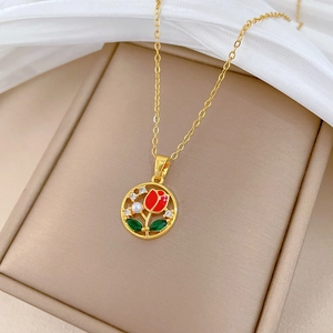 Luxury gold necklace featuring red tulip pendant with cubic zirconia and pearl inlay
