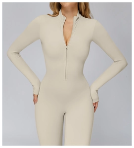 Close-up of beige thermal yoga jumpsuit showing half-zip collar and ribbed texture