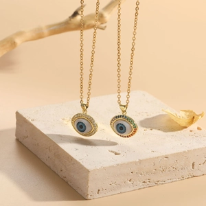 Macro detail of gold-plated evil eye necklaces with colorful zircon and blue eye stones