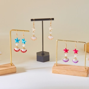 Summer ocean shell earrings with starfish and pearls in blue, beige, and rose pink