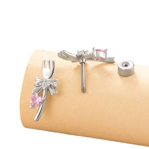 Elegant silver tulip stud earrings with a pink heart zircon and bow tie detail
