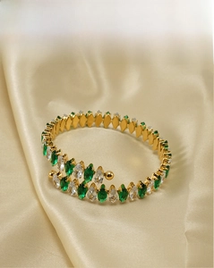 Detail of 18K gold-plated stainless steel bangle with marquise-cut green and white cubic zirconia