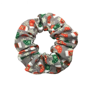 Grey Christmas scrunchie with festive red socks and snowflake patterns on white background
