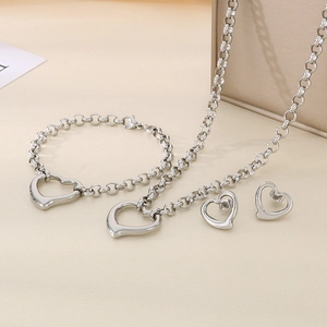 Detailed view of silver stainless steel jewelry set featuring hollow heart pendants
