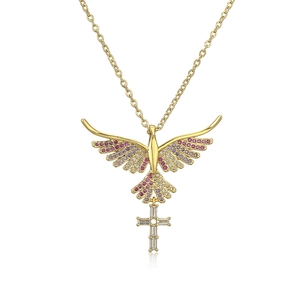Macro detail of gold pigeon pendant with colored stones and a zircon cross on the chain