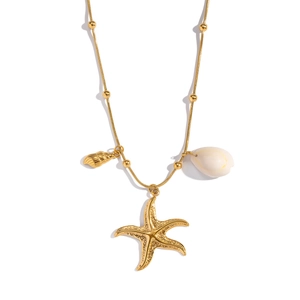Detail view of gold starfish necklace with natural seashell and conch charms on white background