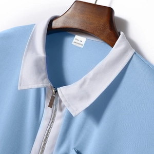 Nahaufnahme eines hellblauen Poloshirt-Kragens mit weißem Rand und Silberreißverschluss
