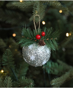 Silver sequin Christmas ball with snowflake pattern, pine needles and pine cones detail
