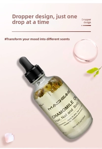 Macro view of 120ml chamomile essential oil bottle with dried flowers and dropper