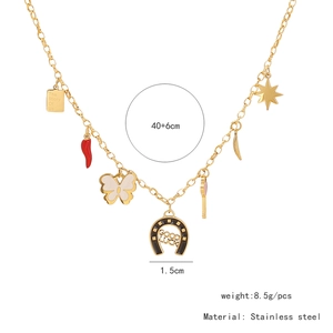 Detail of gold stainless steel necklace with boot bow and multi-charm pendants