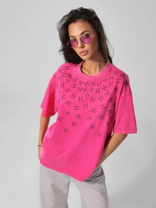 Detail of pink cotton T-shirt featuring vintage wash texture and black H pattern print