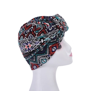 Detail of bohemian turban hat featuring vibrant geometric patterns and side knot design