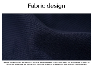 Detailed macro view of dark blue ribbed knit fabric texture with washing instructions