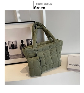 Detail of green hexagonal quilted tote bag with matching mini coin purse attachment
