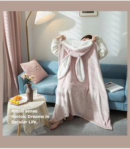 Detailed view of soft pink rabbit ear hooded blanket with white plush fleece lining