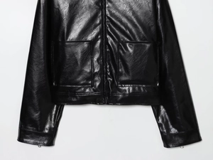 Détails d'une veste en similicuir noir montrant l'ourlet, les poches et la texture
