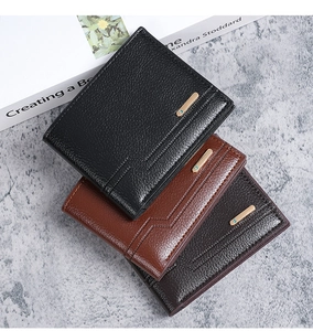 Detailed view of three lychee pattern leather men's wallets with metal buckle accents