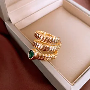 Gold-plated snake spiral ring featuring a pear-shaped emerald green zircon stone