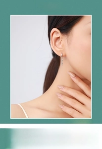 Close-up of S925 sterling silver drop earring with colorful rainbow zircons on model