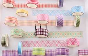 Detailed overhead view of multiple colorful checkered washi tape rolls for DIY crafting