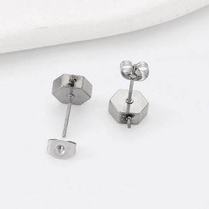 Minimalist silver hexagonal stainless steel stud earrings set on white background